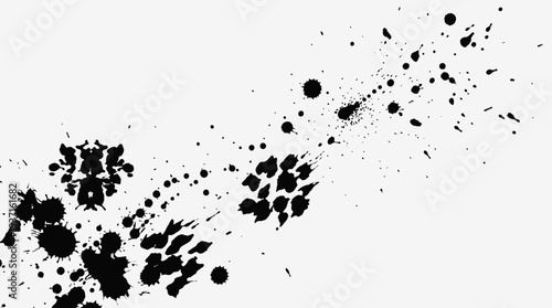 Black ink splatters on a white background, creating an abstract design.