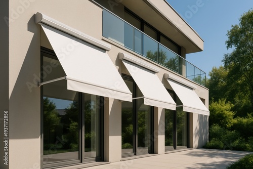 Modern building facade with white retractable awnings and glass balcony outdoors