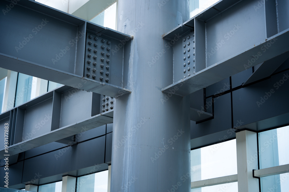 Obraz premium Close-up of steel structural beam and column connection nodes with rivets and bolts