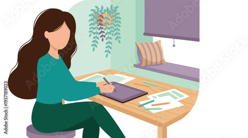 Creative woman drawing with stylus on graphic tablet at a home desk