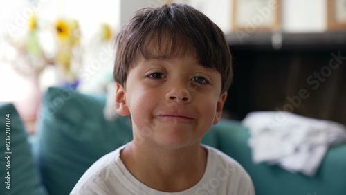 Photos Young boy smirking playfully at camera, confident expression, cheeky smile, chil