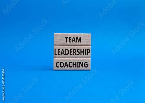 Team leadership coaching symbol. Concept word Team leadership coaching on wooden blocks. Beautiful blue background. Business and Team leadership coaching. Copy space