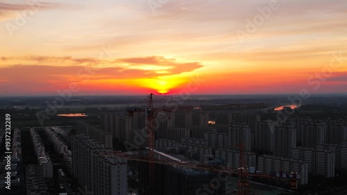 Urban Construction Site at Sunset - Aerial City Skyline View