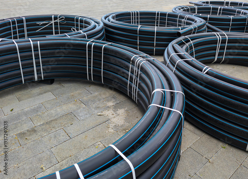 Coils of HDPE pipes were unloaded at a construction site.