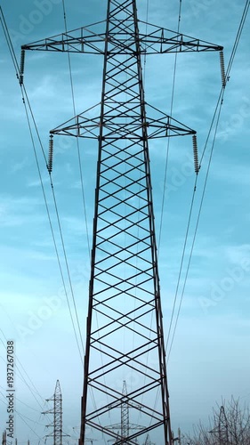 Tall Towers Stretch Across Sky, Metal Lattice Structures Stand Tall Beneath Expansive Blue Sky . Media