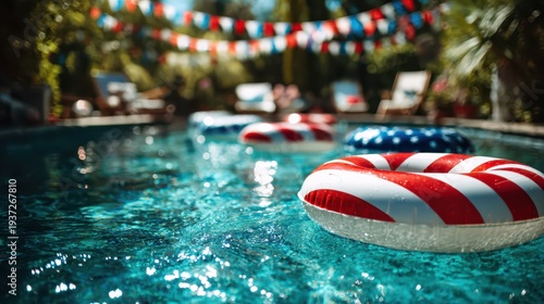 Stunning photo of Summer pool party with patriotic red white and blue inflatable rings and festive bunting decorations
