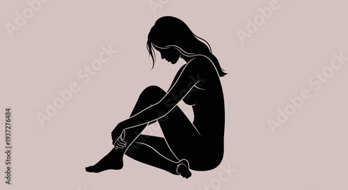 Sad depressed young woman hugging knees, sitting alone on a muted pink background, feeling lonely and contemplative.