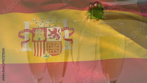 Spanish flag overlay rippling as green bottle entering, tilting, pouring and filling right flute