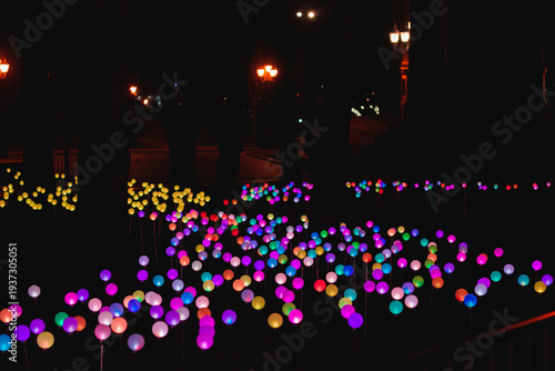 Colorful lights create a bright scene in a park at night during a festive event showcasing community creativity and spirit
