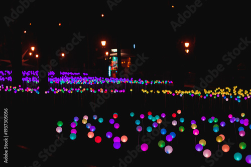 Colorful lights create a bright scene in a park at night during a festive event showcasing community creativity and spirit
