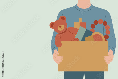 Man holding donation box full of toys and gifts, charity donation concept