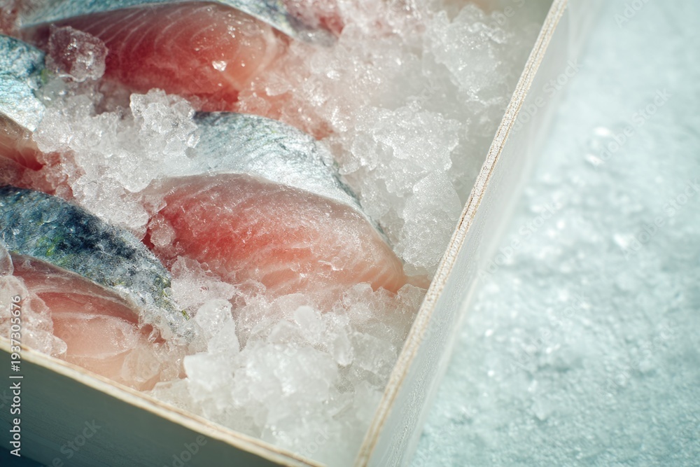 Fototapeta premium Fresh salmon fillets on ice in wooden box