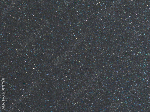 Macro photography of subtle dark grey metallic texture with fine holographic sparkles
