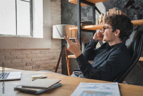 Office, businessman and talking with phone call for negotiation, funding discussion and smile. Career, male person and financial advisor with mobile for communication, offer and networking to contact