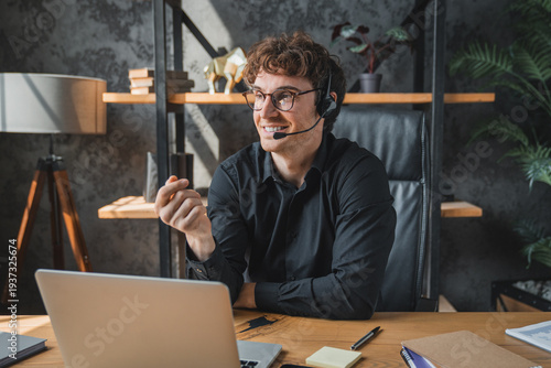 Happy, laptop and young man with microphone on video call for customer enquiry, virtual meeting or campaign update. Agency, specialist and clients support project management or planning