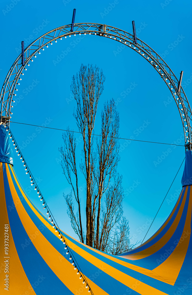 Fototapeta premium Winter landscape on a sunny day with a blue and yellow circus tent at Straubing, Bogen, Bavaria, Germany