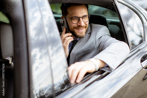 Businessman talks on phone ...