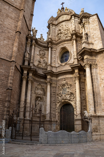 Valencia Cathedral and Miguelete Tower (Micalet) from Plaza de la Reina, Spain. A Gothic masterpiece standing tall, framed by the lively ambiance of one of Valencia’s most iconic squares.