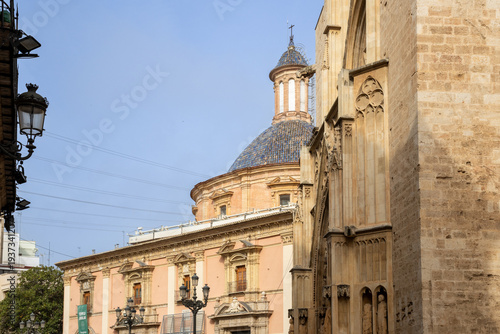 Valencia Cathedral and Royal Basilica of Our Lady of the Forsaken (Real Basílica de Nuestra Señora de los Desamparados) from Plaza de la Virgen, Valencia, Spain. 