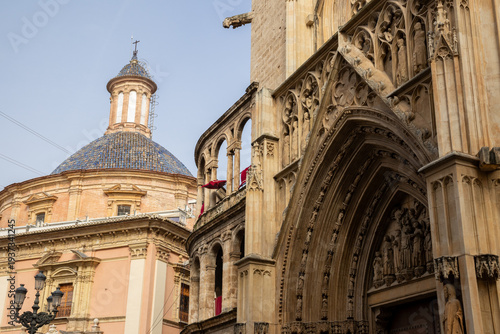 Valencia Cathedral and Royal Basilica of Our Lady of the Forsaken (Real Basílica de Nuestra Señora de los Desamparados) from Plaza de la Virgen, Valencia, Spain. 