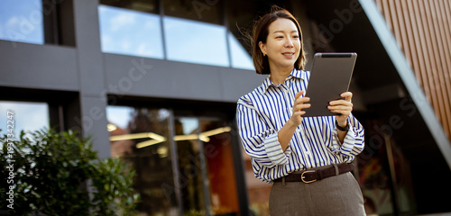 Korean woman using tablet o...
