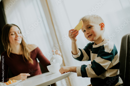 Child enjoys a snack with m...