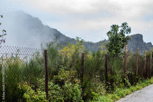 Chain Link Fence and Misty Volcanic Ridges on Mount Vesuvius Italy