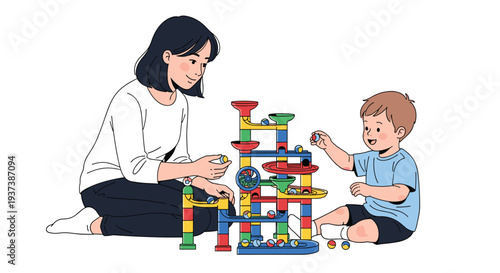 A mother and a young boy are seated on the floor, happily constructing and playing with a vibrant, multi-level marble run toy.