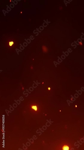 Glowing fire embers floating in dark background