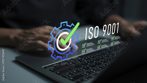ISO 9001 certification concept. Person using laptop with ISO 9001 standard and approval icons, quality management system, compliance verification and business process improvement.