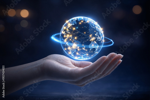 A glowing holographic Earth slowly spins above an open hand in the dark. Bright digital lines circle the planet, symbolizing global connection, technology, and the future of communication.