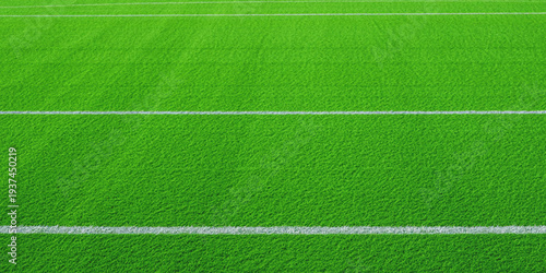 Quadro su tela A vibrant green sports field with white yard lines creating a symmetrical patter