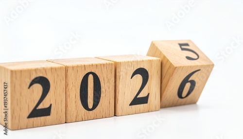 Wooden blocks showing the year 2026, with a block flipping from 5 to 6, symbolizing a transition.