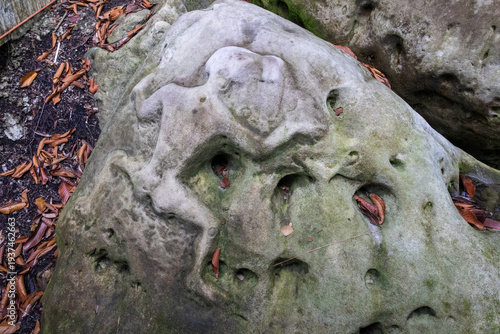 Photography Rock carvings of human figures carved into sandstone boulders located at Santubong Archaeological Park in Kuching, Malaysia