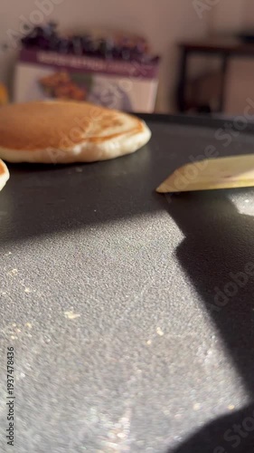 Close-up video of a golden pancake cooking in a hot pan, showing the crispy texture and smooth batter. Perfect for food preparation and breakfast cooking content.