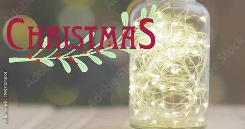 Obraz Glowing glass jar holding warm lights on wood table, red CHRISTMAS with green sprig, copy space