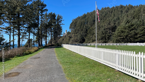 White picket fence in front of assistant light keeper's house leading the way to Heceta Head Lighthouse