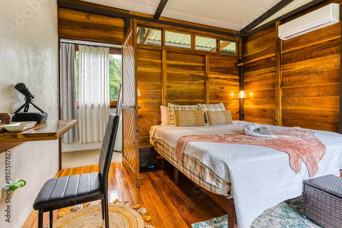 Cozy wooden cabin room with bed and desk