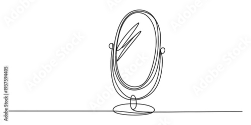 Standing oval mirror with pencils on table, simple still life