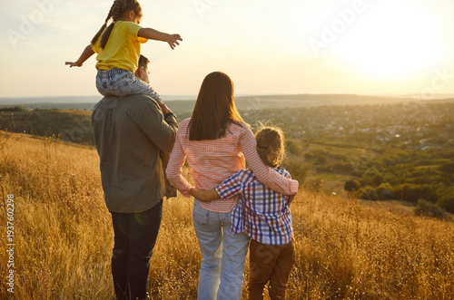 Canvastavla Happy family together at sunset, parents hug children outdoors