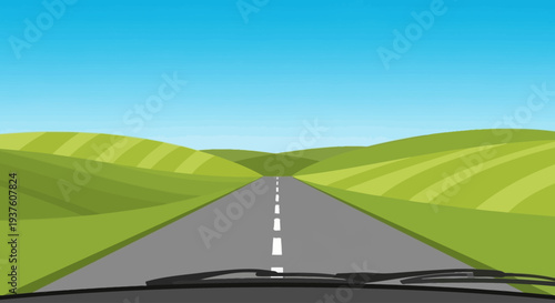 Open road through rolling green hills under a blue sky