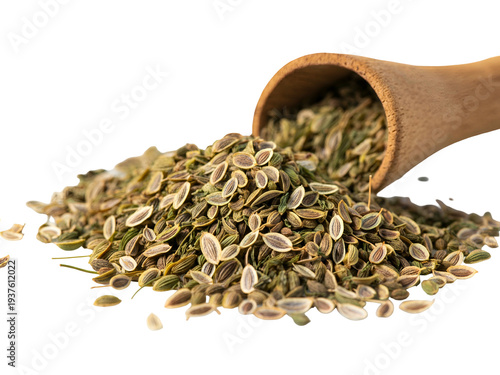 A wooden spoon spilling dried dill seeds onto a white surface, showcasing aromatic herbs for cooking and seasoning