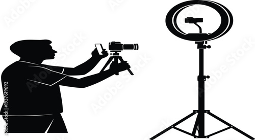 Silhouette of Photographer Using Camera on Tripod and Smartphone with Ring Light Equipment in Studio for Content Creation