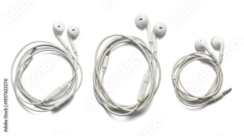 three pairs of white earbuds, each coiled and presented with their audio connector, isolated on a pure transparent background for clear focus.