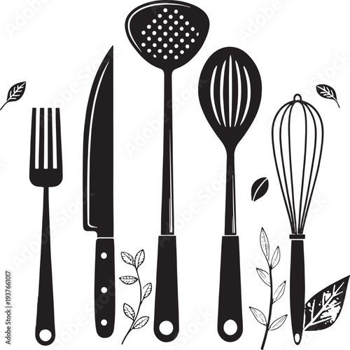 Black kitchen utensils and leaves on white background fork knife skimmer slotted spoon whisk