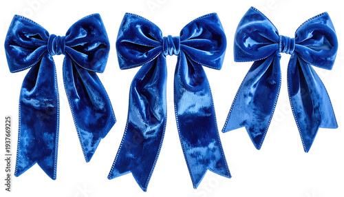 Three plush, blue velvet bows on a stark black background, showcasing intricate folds and subtle texture variations