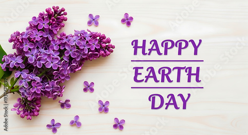 Purple lilac flowers with Happy Earth Day text on wooden background