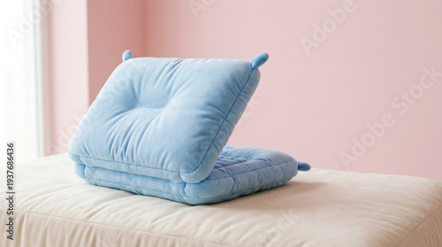 Cozy Cushion Serenity: A soft, baby blue cushion sits invitingly on a bed, perfect for relaxation and providing a comforting haven. The gentle colors create a peaceful and serene environment.