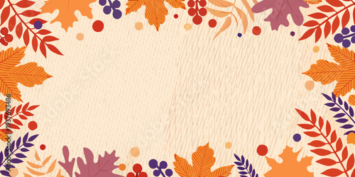 Autumn leaves and berries create a decorative frame on wood texture