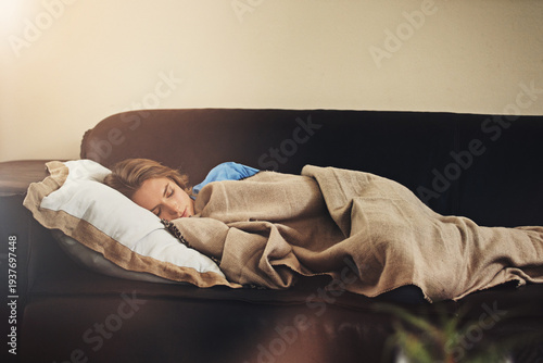 Photos Couch, sleep and woman with blanket in home for relax, peace or calm on weekend break in living room